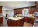 Spacious kitchen with large island, stainless steel appliances, and ample cabinet space at 17575 E Kettle Pl, Centennial, CO 80016