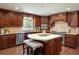 Gourmet kitchen boasts dark wood cabinets and expansive island at 17575 E Kettle Pl, Centennial, CO 80016