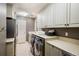 Laundry room with washer, dryer, and ample counter space at 17575 E Kettle Pl, Centennial, CO 80016