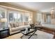 Cozy living room featuring a comfortable sofa and large windows at 17575 E Kettle Pl, Centennial, CO 80016