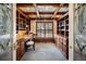 Home office with built-in bookshelves and wood ceiling at 17575 E Kettle Pl, Centennial, CO 80016