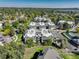 An aerial view features the community's layout, green spaces, parking, and surrounding trees at 1820 Newland Ct # 213, Lakewood, CO 80214