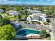 A higher aerial view showing the parking and pool, with landscaping and distant mountain range at 1820 Newland Ct # 213, Lakewood, CO 80214