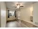 Bright bedroom with wood-style floors, a large window, and ensuite bathroom access at 1820 Newland Ct # 213, Lakewood, CO 80214