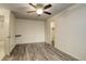 This bedroom is spacious and bright with hardwood style floors and a ceiling fan with lighting at 1820 Newland Ct # 213, Lakewood, CO 80214