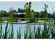 Scenic community park features a peaceful lake with green trees and walking trails at 1820 Newland Ct # 213, Lakewood, CO 80214
