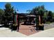 Exterior view of festive open air courtyard with covered seating and landscaping at 1820 Newland Ct # 213, Lakewood, CO 80214