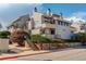 Two-story townhome building with well-kept landscaping and exterior stairs leading to upper units at 1820 Newland Ct # 213, Lakewood, CO 80214