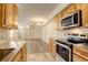 Well-equipped kitchen overlooking the spacious living room with stainless steel appliances at 1820 Newland Ct # 213, Lakewood, CO 80214