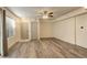 Spacious room with wood flooring, a ceiling fan, neutral paint, and good natural light, great for entertaining or relaxing at 1820 Newland Ct # 213, Lakewood, CO 80214