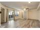 Large room with wood flooring, a ceiling fan, neutral walls, and sliding glass door access to the outside at 1820 Newland Ct # 213, Lakewood, CO 80214