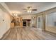 Open-concept living area with adjacent kitchen, fireplace, and neutral paint at 1820 Newland Ct # 213, Lakewood, CO 80214
