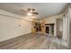 Open-concept living room with wood flooring and fireplace next to an adjacent, fully-equipped kitchen at 1820 Newland Ct # 213, Lakewood, CO 80214