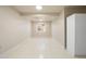 Clean basement with neutral walls, tile flooring, and a bright window offering versatility for various uses at 2245 Ridgeview Way, Longmont, CO 80504