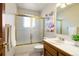 Bright bathroom with a tub shower, and floral decor at 2245 Ridgeview Way, Longmont, CO 80504