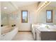 Bathroom featuring double vanity, soaking tub and large windows that provide lots of light at 2245 Ridgeview Way, Longmont, CO 80504