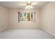 Empty bedroom featuring a large window providing natural light and a neutral color palette at 2245 Ridgeview Way, Longmont, CO 80504