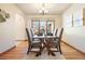 Dining room featuring hardwood floors, neutral decor, and a large window at 2245 Ridgeview Way, Longmont, CO 80504