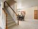 View of dining room with stairway, a modern chandelier and decorative artwork adding to the home's character at 2245 Ridgeview Way, Longmont, CO 80504