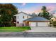 Charming home exterior with a well-maintained lawn, mature trees, and a spacious two-car garage at 2245 Ridgeview Way, Longmont, CO 80504
