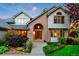 Beautiful front exterior with brick accents, lush landscaping, and an arched entryway for added charm at 2245 Ridgeview Way, Longmont, CO 80504