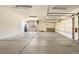 Spacious garage featuring a concrete floor, ample lighting, and an open garage door at 2245 Ridgeview Way, Longmont, CO 80504