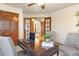 Cozy office with wooden desk, two chairs, and view into the entry and dining area at 2245 Ridgeview Way, Longmont, CO 80504