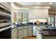 Kitchen with black countertops, stainless steel appliances, and hardwood floors at 2245 Ridgeview Way, Longmont, CO 80504
