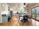 Open-concept kitchen and dining area with modern appliances and access to an outdoor deck at 2245 Ridgeview Way, Longmont, CO 80504
