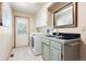 Bright laundry room features modern appliances, tile flooring and access to the backyard at 2245 Ridgeview Way, Longmont, CO 80504