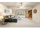 Spacious living room with natural light, a comfortable seating area, and built-in shelving at 2245 Ridgeview Way, Longmont, CO 80504