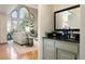 Sun-filled living room featuring large arched windows with a dry bar area nearby at 2245 Ridgeview Way, Longmont, CO 80504