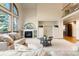 Cozy living room showcasing a fireplace, built-in shelving, large arched windows, and plush seating arrangement at 2245 Ridgeview Way, Longmont, CO 80504