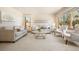 Bright living room showcasing neutral tones, comfortable seating, and large windows offering ample natural light at 2245 Ridgeview Way, Longmont, CO 80504