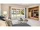 Bright living room featuring a comfortable couch, natural light, and a built-in bookshelf at 2245 Ridgeview Way, Longmont, CO 80504