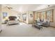 Spacious main bedroom with sitting area featuring neutral tones, windows, and sliding glass door at 2245 Ridgeview Way, Longmont, CO 80504