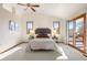 Bright bedroom with large windows and sliding glass door that provides plenty of natural light at 2245 Ridgeview Way, Longmont, CO 80504
