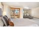 View of the main bedroom with sitting area and sliding glass door to the balcony at 2245 Ridgeview Way, Longmont, CO 80504