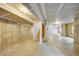 Unfinished basement featuring concrete walls, beams, and rough-in plumbing at 14333 E Napa Pl # 5D, Aurora, CO 80014