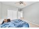 Bright bedroom featuring a ceiling fan and large closet with sliding doors at 14333 E Napa Pl # 5D, Aurora, CO 80014