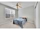 Cozy bedroom features a ceiling fan, window with blinds, and a closet at 14333 E Napa Pl # 5D, Aurora, CO 80014
