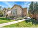 Charming home with stone accents, well-maintained lawn, and inviting walkway at 14333 E Napa Pl # 5D, Aurora, CO 80014