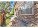 Stone clad entrance featuring a stone column, steps, and manicured landscaping at 14333 E Napa Pl # 5D, Aurora, CO 80014