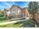Inviting home exterior with stone accents, mature landscaping, and a welcoming entryway at 14333 E Napa Pl # 5D, Aurora, CO 80014