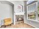 Cozy fireplace with tile surround and mantel, next to a sunny window at 14333 E Napa Pl # 5D, Aurora, CO 80014