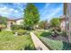 Beautifully landscaped front yard with mature trees and a well-manicured lawn at 14333 E Napa Pl # 5D, Aurora, CO 80014