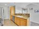 Kitchen area featuring wooden cabinets, tile countertops, stainless steel appliances, and functional layout at 14333 E Napa Pl # 5D, Aurora, CO 80014