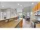 Open kitchen area featuring wood cabinets, stainless steel appliances, with views to the living and dining areas at 14333 E Napa Pl # 5D, Aurora, CO 80014