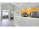 Well-lit kitchen featuring a serving bar, wooden cabinets, stainless steel appliances, and an open layout at 14333 E Napa Pl # 5D, Aurora, CO 80014