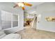 Open-concept living area with tiled floors, leading to the kitchen and staircase to the second floor at 14333 E Napa Pl # 5D, Aurora, CO 80014